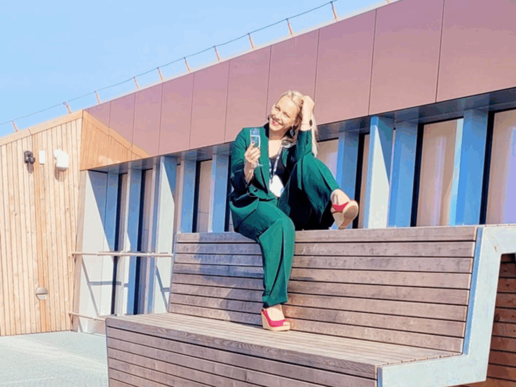 Woman in a green suit on the VIZIUM Science Centre viewing platform in Ventspils on a sunny day