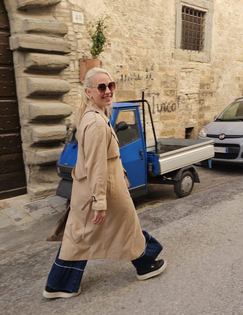 Woman walking through an Italian street, experiencing everyday life after moving to another country